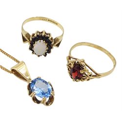 Gold oval blue topaz pendant necklace, opal and sapphire cluster ring and a gold single stone garnet ring, all 9ct