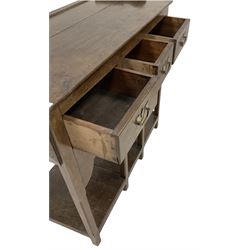 Oak dresser, the projecting cornice over two height plate rack over three drawers and pot board base