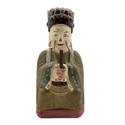 Chinese carved wood and painted archaic style figure decorated in red, black etc and holding a tablet and with a removeable patch in the back H30cm 