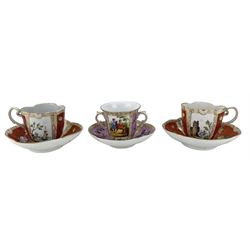 Pair of Meissen cabinet cups and saucers of lobed oval design decorated with coastal scenes, flower heads etc on an ochre ground and a Dresden two handled cabinet cup and saucer with panels of figures and flowers (3)