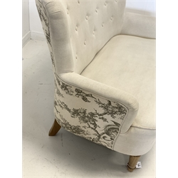 Traditional 'Loveseat' two seat sofa, upholstered in oatmeal buttoned linen, with feature toile fabric design to reverse, raised on turned front supports 