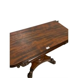 Victorian mahogany fold over tea table, the fold over top raised on octagonal column, leading to base with paw feet