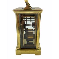 An early 20th century eight-day French Corniche cased timepiece carriage clock with a platform cylinder escapement, bevelled glass panels to case and a rectangular glass panel to the top of the case, white enamel dial with Roman numerals and minute markers, steel hands, dial inscribed 