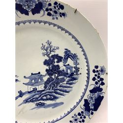 18th century Chinese Export porcelain blue and white charger, centrally decorated with pagoda beneath a rocky outcrop on the shore of a lake within a scroll border and floral sprays around the rim D42.5cm, together with three further 18th century Chinese blue and white plates, one painted with a similar pagoda scene, the second painted with chrysanthemum and floral sprigs and a the last with a pine tree within geometric borders (4) 