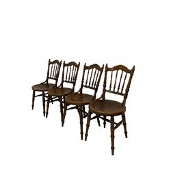Ibex - set four dining chairs, the cresting rail with carved fruit and foliate design over spindle back and circular seats, raised on turned supports 
