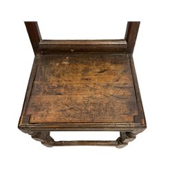 17th century oak backstool, the back panel carved with twin rosettes in a foliate edged border, the panelled seat over a plain front rail, raised on turned front supports united by a box stretcher
