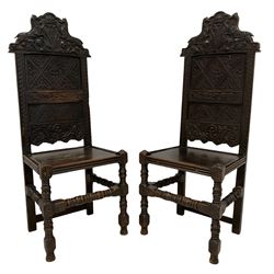 Pair 18th century oak chairs, the cresting rail carved with heraldic shield possibly for Arms of Paulet, Marquess of Winchester, three daggers on shield surmounted by crown and flanked by rearing horses, the panelled backs carved with foliate and guilloche, turned supports joined by stretchers, W47cm, H120cm