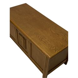 Oak blanket box, the lifting top over three panelled front, decorated with linen carving, raised on stile supports W107cm, H51cm, D46cm