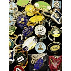 Seventy-five 1970s, 80s, 90s and early 2000s York enamel members' racecourse badges, together with a bronzed example for the year 2000 (76)