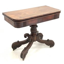 Late Georgian Irish mahogany tea table, the fold over revolving top over waterleaf carved and turned column, raised on four 's' scrolled and leaf caved supports terminating in castors W91cm