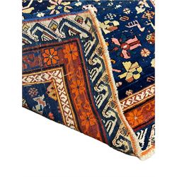 Persian blue ground rug, the field decorated with five large Herati motifs and stylised flower heads, repeating rust ground border bands