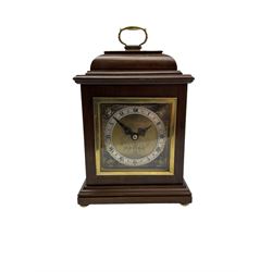 20th century mahogany cased table clock with a spring driven Elliott movement, with a brass dial and timepiece movement wound and set from the rear. Dial inscribed “ J.W. Benson, London”
