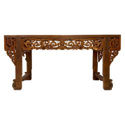 Large 19th century Chinese hardwood altar table, rectangular top over frieze pierced and carved with scrolls and dragon heads, the upright supports carved with vase and trailing foliate, scroll carved and pierced corner brackets and panelled sides