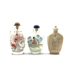 Two Chinese inside-painted glass snuff bottles, together with an early 20th century ivory snuff bottle carved with scholars to one side and inscribed peacock to the other, signed, max H8.5cm (3)