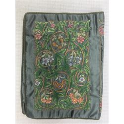 19th century embroidered binding, ‘De Rebus’, green silk ground embroidered with scrolling foliage and flowers within a rectangular panel, the spin with stitched title, border and sprigs of flowers and the owners monogram to the other side, 30cm x 20cm 