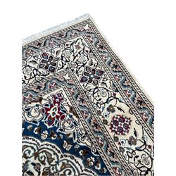 Perisan Kashan ivory ground rug, the field decorated with interlacing branches and stylised plant motifs, central floral medallion, repeating border decorated with scrolling and flower head motifs