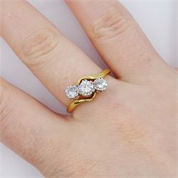 18ct gold three stone round brilliant cut diamond crossover ring, stamped, total diamond weight approx 0.75 carat