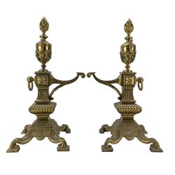 Pair of late Victorian cast and gilt brass fire dogs, circa 1894,with flaming urn finials raised upon columnar supports and four scroll feet, Rd227713, H47cm  