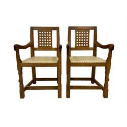 Rabbitman - pair of Yorkshire oak armchairs, the lattice back over studded hide upholstered seat, raised on faceted octagonal supports united by stretchers, carved with Rabbit signature, by Peter Heap of Wetwang