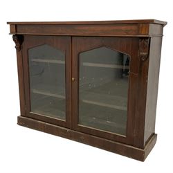 Victorian rosewood side cabinet, rectangular top over two arch glazed doors, the uprights with acanthus carved S-scroll brackets, on plinth base