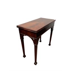 George III mahogany tea table, the fold over top over blank frieze raised on square tapering supports, terminating in spade feet
