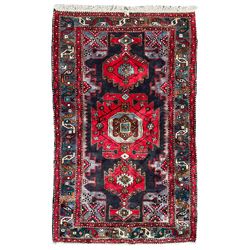 Persian Hamadan indigo ground rug, with central pole medallion decorated with stylised flower heads and central Boteh, the border decorated with trailing geometric and interlocking band  