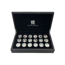 The Royal Mint London 2012  'A Celebration of Britain' silver proof five pound coin set, eighteen coins each bearing the coloured London Olympics 2021 logo,  cased with certificates (damage to the case)