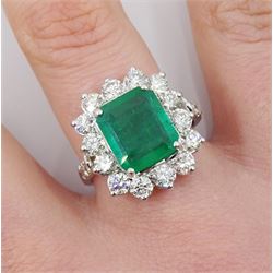 18ct white gold emerald and round brilliant cut diamond cluster ring, with diamond set shoulders, stamped 18K, emerald 3.40 carat, total dimaond weight 1.70 caratwith World Gemological Institute Report