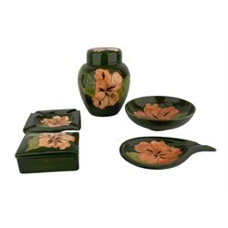 Moorcroft pottery Hibiscus pattern ginger jar and cover on a green ground with printed paper label 'Potter to the late Queen Mary'  H15cm, matching bowl D14cm, rectangular box and cover W9.5cm and two ashtrays (5)