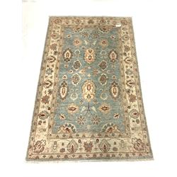 Persian design ground rug, blue field with interlaced floral design, enclosed by an ivory guarded boarder. W120cm L195cm.