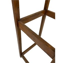 20th century oak hat and coat stand, fitted with brass hooks and raised on square supports, united with stretchers 