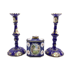 Late 18th century Bilston enamel octagonal tea caddy, the blue ground decorated with Rococo style white enamel cartouches containing landscape scenes with figures and animals together with a pair of matching candlesticks, H27cm 