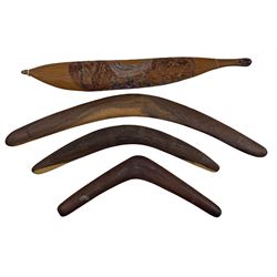 Australian Aboriginal spear thrower with painted decoration inscribed 'Hermannsburg, Central Australia' L70cm, boomerang with ridged decoration L73cm and two others (4)
