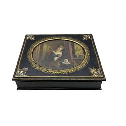 Victorian papier mache writing slope decorated with gilt and mother of pearl, the hinged cover inset with an oval print of an interior scene W32cm
