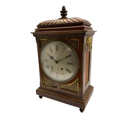 Winterhalder and Hoffmeier striking mantle clock in a mahogany case with a carved gadrooned top surmounted by a turned wooden finial, with applied brass decoration, inlay and silk backed sound frets, circular silvered dial with Roman numerals, minute track and steel hands (minute hand replaced) with a convex glass and brass bezel, twin eight-day going barrel movement striking the hours and half hours on a coiled steel gong. With Pendulum.  
Winterhalder and Hoffmeier were one of the leading German clock manufacturers of the 19th and early 20th century from 1850 to1933.



