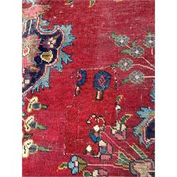 Persian design red ground carpet, floral medallion and conforming spandrels on red field enclosed by border 325cm x 220cm