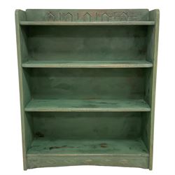 Green painted bookcase, tapered form and fitted with three shelves, with geometric carved decoration, painted and waxed finish