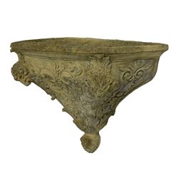 Composite stone wall pocket or planter, decorated with rams head and foliate decoration