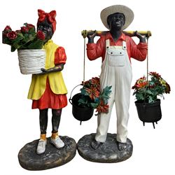 Pair of fibre glass figures in the form of a boy and girl wearing provincial costume both with hanging baskets for flowers H112