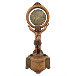 Victorian carved oak gong stand in the form of a Cherub supporting a circular walnut frame with central brass gong, on shaped walnut plinth with beater, H131cm 