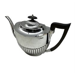 Silver three piece tea set of oval design with half body reeded decoration, the teapot with ebonised handle and lift Sheffield 1918 Maker Viners Ltd 44oz gross