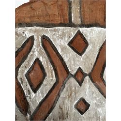 Asmat war shield, Papua New Guinea, circa 1900, carved wood and pigment, the motifs represent the flying fox (tar) and rhombic shapes, with an integral handle to the reverse, L170cm x W59cm 