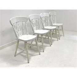 Set four white painted dining chairs, spindle and splat back over saddle seats, raised on ring turned supports united by stretchers 