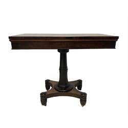 William IV rosewood card table, the rectangular hinged swivel top revealing green baise inset with crossbanding, the lappet carved pedestal and collar terminating in a concave sided quadripartite platform, raised on turned feet with brass castors