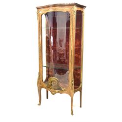 20th century French kingwood serpentine vitrine, with marble top over floral cast gilt metal mounts, glazed door with signed painted panel enclosing three glazed shelves and a red velvet lined interior, raised on slender shaped supports with sabot feet W73cm, H160cm, D37cm