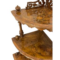 Victorian figured walnut corner whatnot, fretwork pediment over four graduating tires, on turned and lobe carved supports, inlaid with boxwood stringing and trailing foliate decoration, turned feet on brass and ceramic castors 