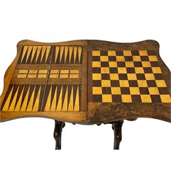 19th century figured walnut games table, the shaped fold-over swivel top revealing chess, backgammon and cribbage boards, frieze drawer over sliding shaped storage well, on twin turned pillars joined by double stretchers, foliate carved splayed supports on castors
