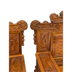 Pair Chinese Imperial style hardwood throne chairs, the backs carved with dragon masks and birds in naturalistic landscapes,  uprights fitted with two small drawers, on block supports, carved with scrolling foliate and traditional Chinese motifs