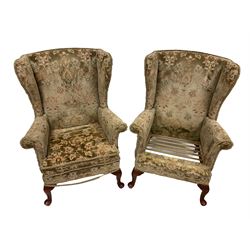 Parker Knoll - pair wingback armchairs upholstered in beige patterned fabric, raised on cabriole supports (one cushion missing)