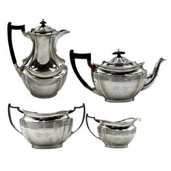 Silver four piece tea set of panelled oval form with gadrooned border, the tea pot and hot water jug with ebonised handles and lifts, presentation inscription to the hot water jug and monogram to the remaining pieces Chester 1923/4/5 Maker Barker Bros. 50oz gross